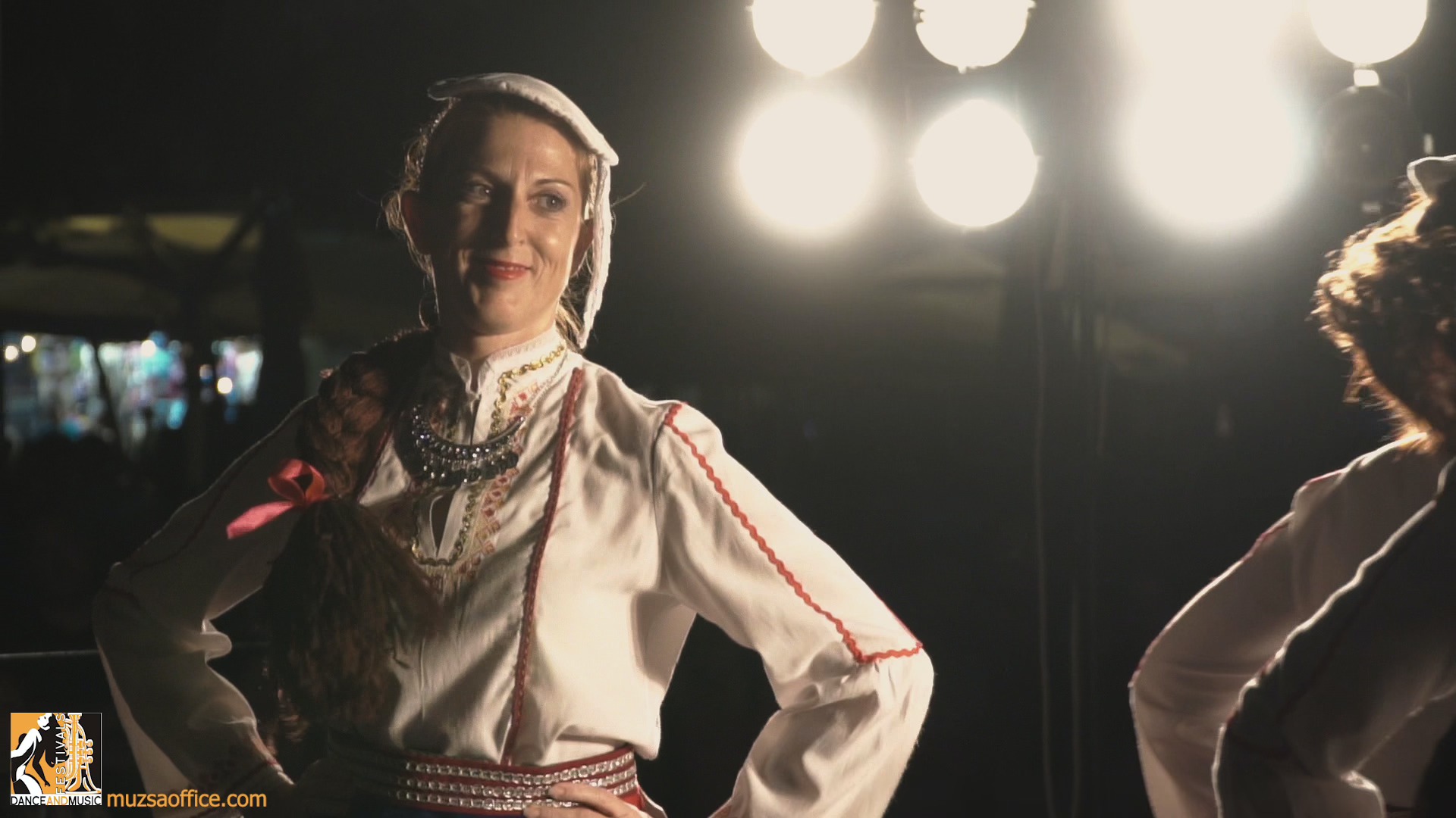 Vibrant folk dancers in traditional attire performing at a European folklore festival for choirs, dance groups, and music bands.