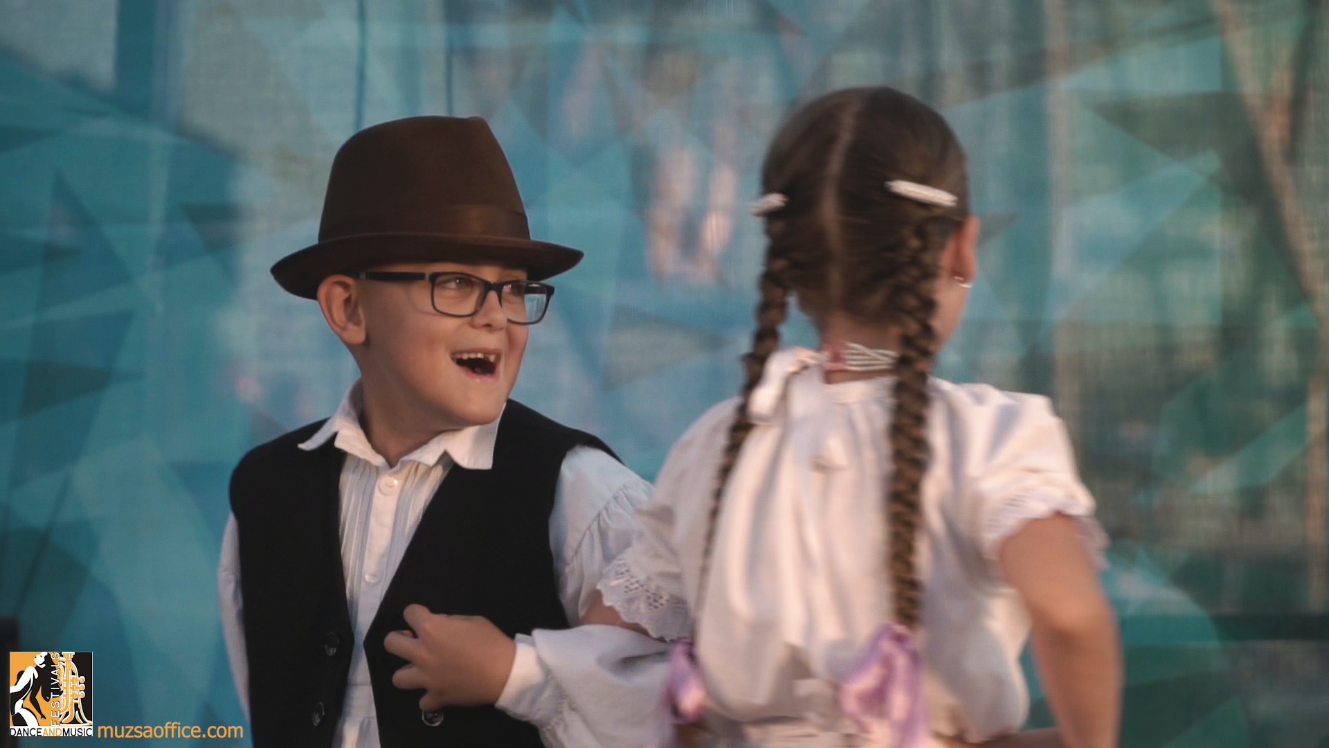 Dancers in traditional costumes representing their culture at a European festival for choirs, music bands, and modern dance groups.