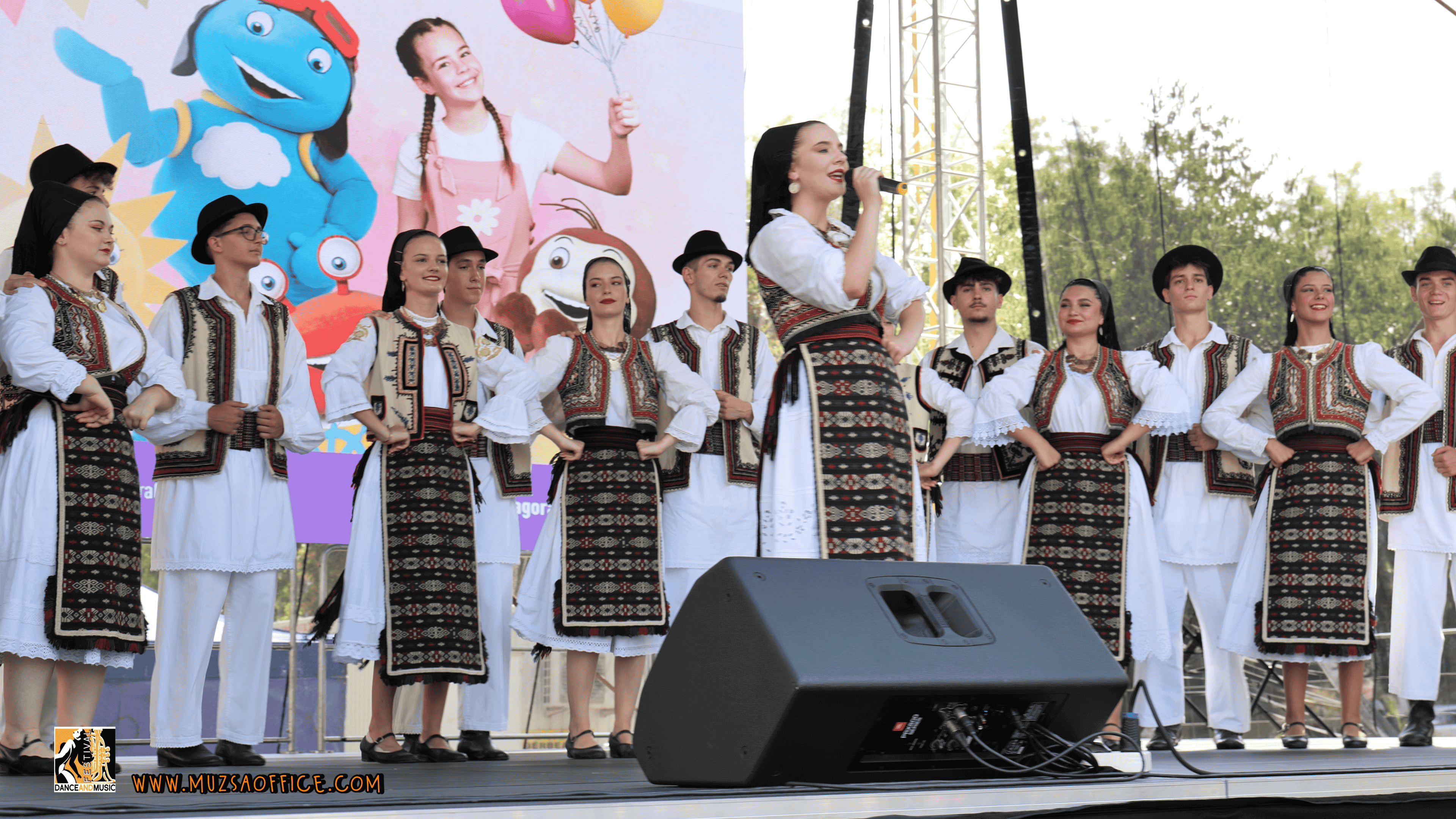 A modern dance group performing on stage.